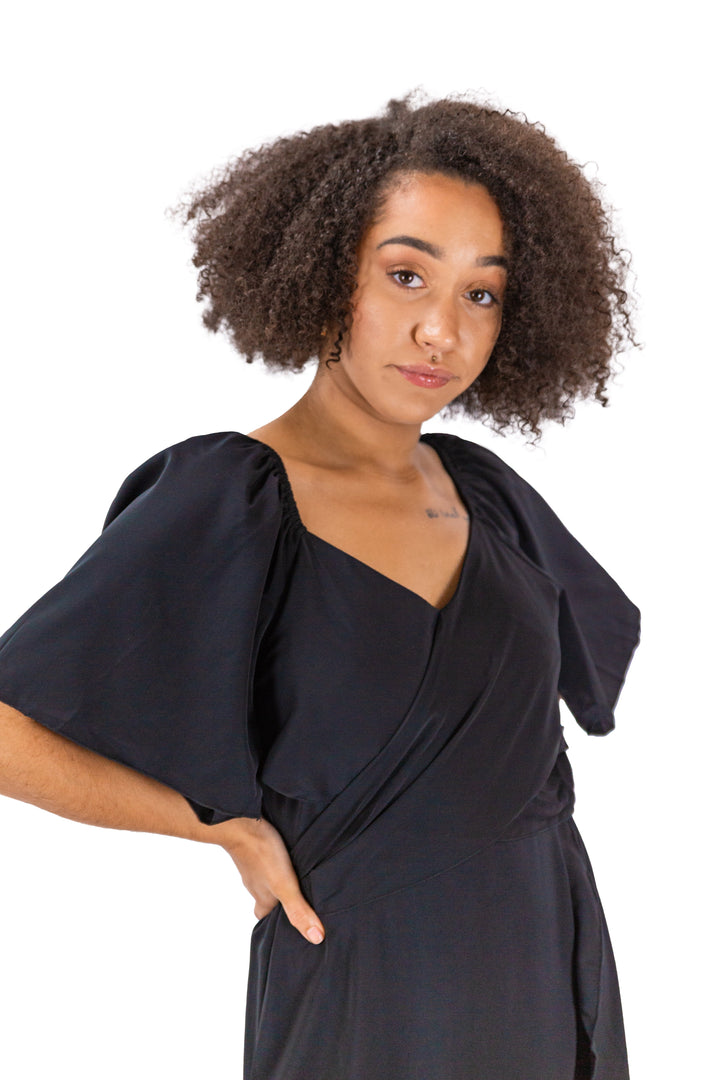Elegance Unveiled: Black Dress with Tie Back and Ruffle Hem
